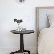 Sculptural bedside table and modern sconce